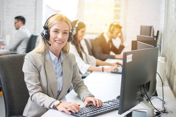istock Young blonde female receptionist with headset in office 1191015287