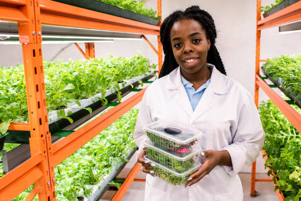 istock Young successful female agronomist in whitecoat holding plastic containers 1191015407