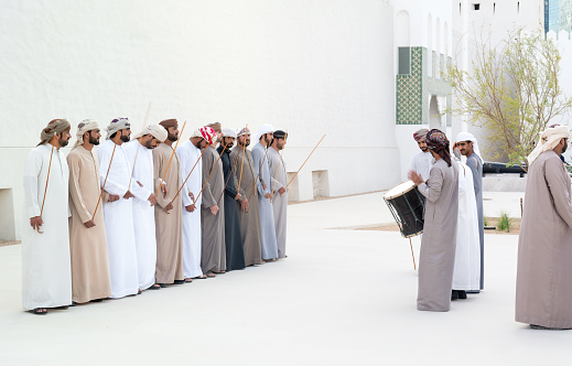 Emirati Men performing the Yowla, a traditional dance in the heritage of UAE\n\n- Abu Dhabi, UAE - February 22, 2019