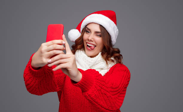 istock Funny female taking Christmas selfie 1191024648