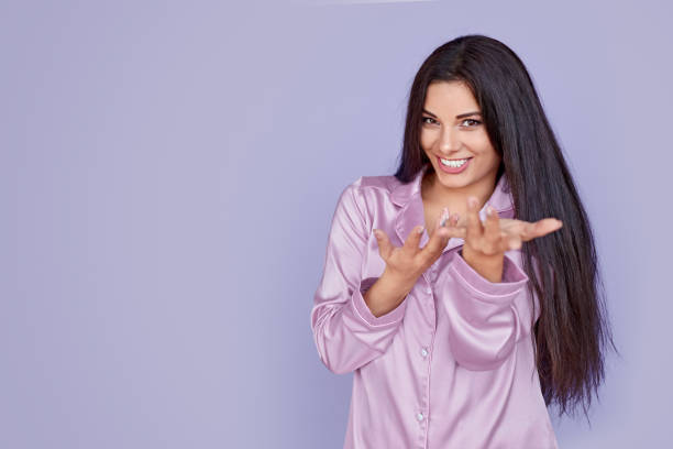 istock Smiling woman in pajama making inviting gesture 1191024746