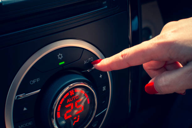 istock Young girl clicked on the automatic button of the automatic air conditioning control panel with a 25 degree Celsius adjustment. 1191025175