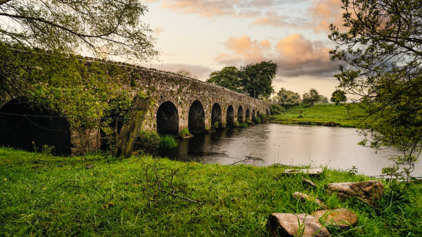 istock Old 12th century stone arch bridge over a river. Count Meath, Ireland 1191026865