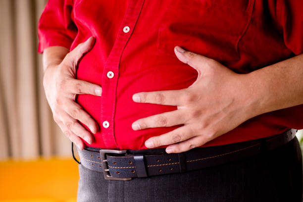 istock Fat man holding his stomach 1191027048