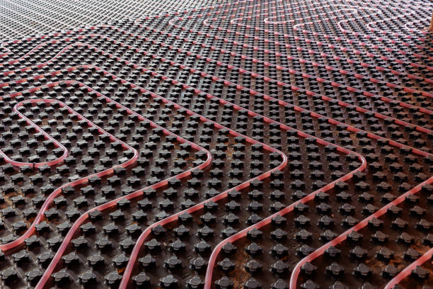 Underfloor heating system installation. Close up on water floor heating system interior of a new residential building. Pipes filled with propylene glycol. Individual Heating.