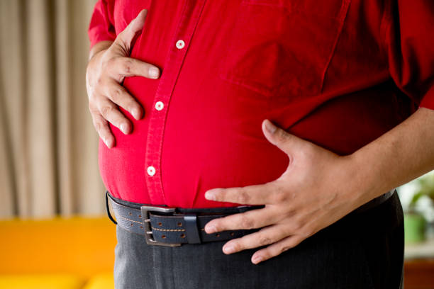 istock Fat man holding his stomach 1191028729