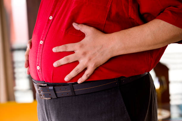 istock Fat man holding his stomach 1191028756