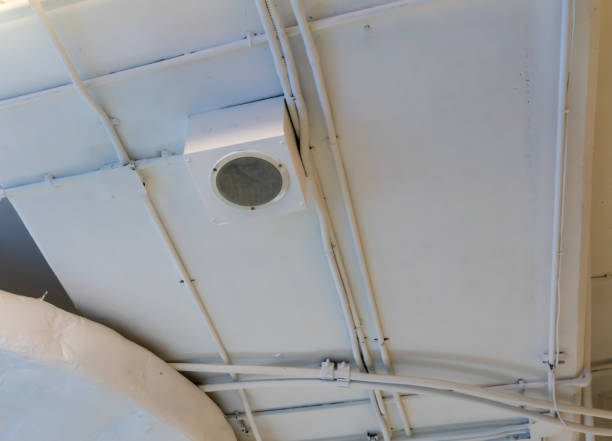 istock White round circle speaker and grille hanging on white ceiling. 1191029963