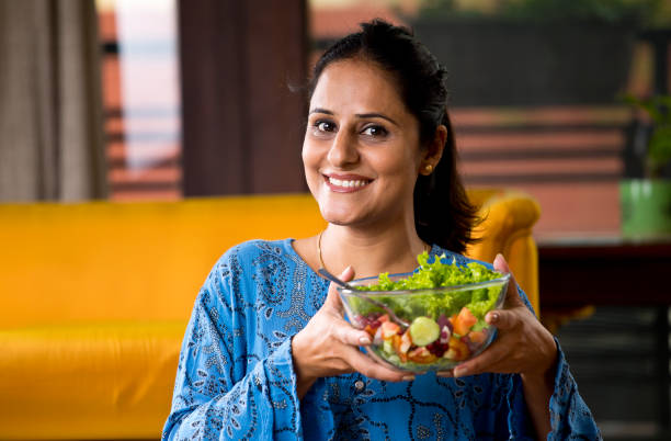 istock Woman eating fruit salad 1191031229