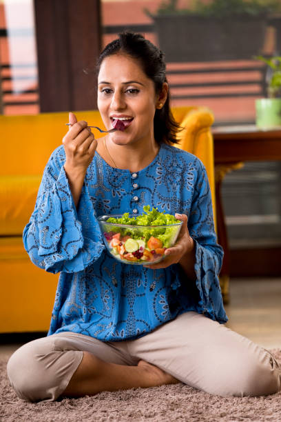 istock Woman eating fruit salad 1191031263