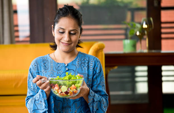 istock Woman eating fruit salad 1191031283