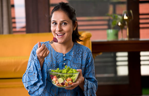 istock Woman eating fruit salad 1191031353