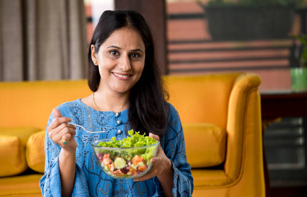 istock Woman eating fruit salad 1191031485