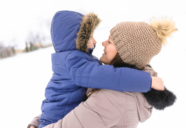 istock Mother and son having fun on snow. Winter joy 1191034442