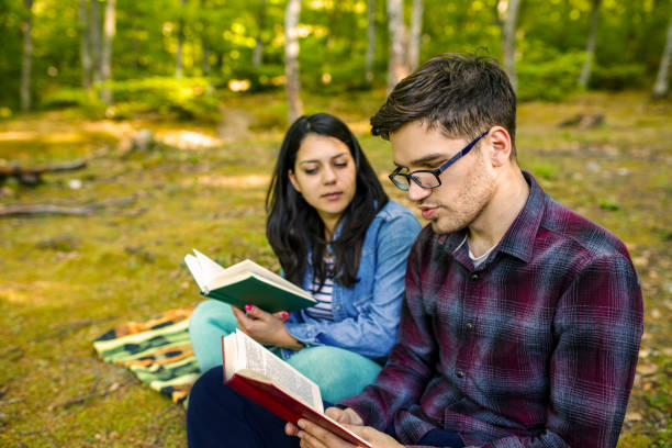 istock Couple Reading a Book On a Picnic 1191036427