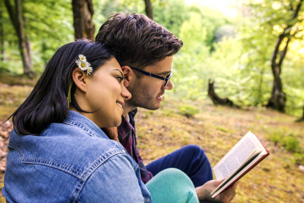 istock Couple Reading a Book On a Picnic 1191037018