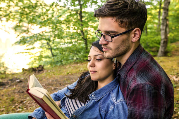 istock Couple Reading a Book On a Picnic 1191037060
