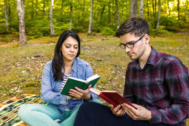 istock Couple Reading a Book On a Picnic 1191037132