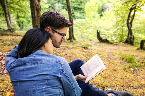istock Couple Reading a Book On a Picnic 1191037144