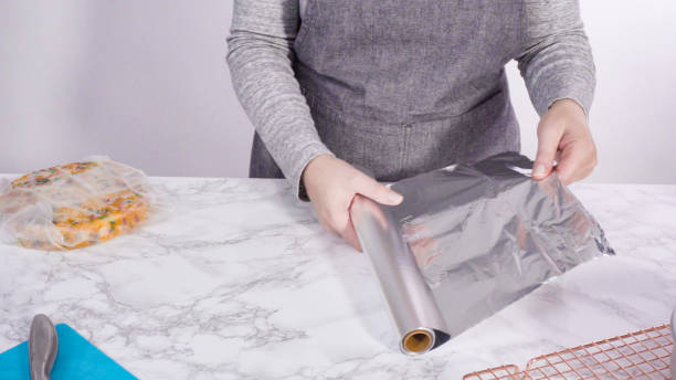 istock Wrapping freshly baked funfetti cake into cellophane 1191038233