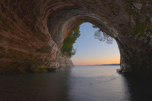 Landscape at sunrise of the interior of Cathedral Sea Cave, Grand Island, Lake Superior, Michigan’s Upper Peninsula, USA