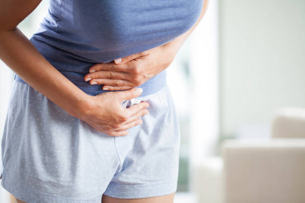 Woman with menstrual pain Young woman having painful stomach ache. Chronic gastritis. Stomach or menstrual cramps. Abdomen bloating concept. colorectal cancer photos stock pictures, royalty-free photos & images