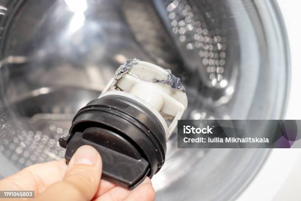 Inspecting Washing Machines Dirty Clogged Drain Pump Filter Close Up Clean And Repair Stock Photo - Download Image Now