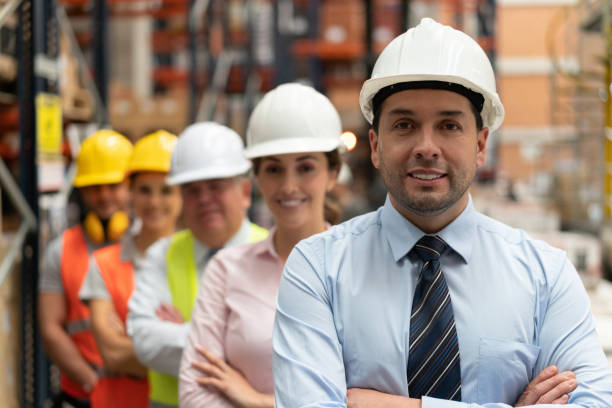 istock Business man leading a group of workers at a warehouse 1191049728