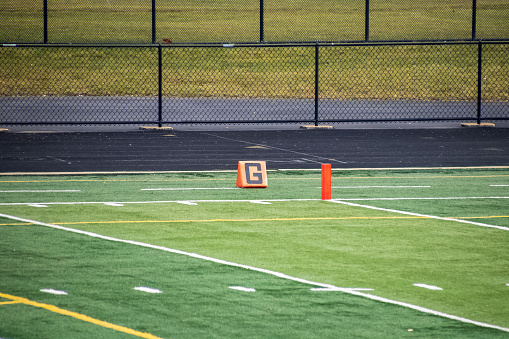 istock Goal line marker "G" on American football field of turf 1191051893