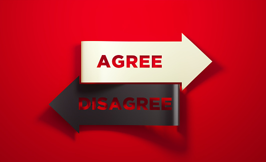 Black and white arrows pointing opposite directions on red background. Agree and disagree antonym reads on the arrows. Dilemma and choice concept. Horizontal composition with copy space.