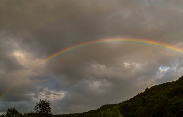 istock Beautiful rainbow profiled on stormy sky, in the mountains 1191053802