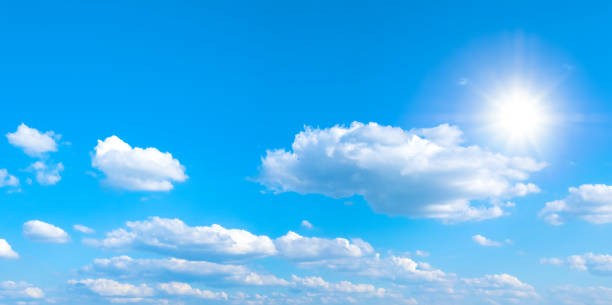 istock Beautiful blue sky with white clouds and sun, sunlight background panorama 1191053835
