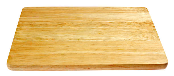 A wooden cutting board, cleaned and ready to be used stock photo