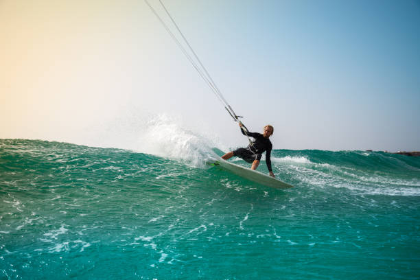 The kite surfer rides the waves of the Atlantic Ocean The kite surfer rides the waves of the Atlantic Ocean on the Fuerteventura island, Canary Islands kiteboard stock pictures, royalty-free photos & images