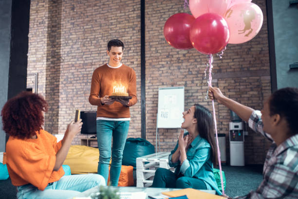 istock Student feeling thankful while friends congratulating her on birthday 1191064565