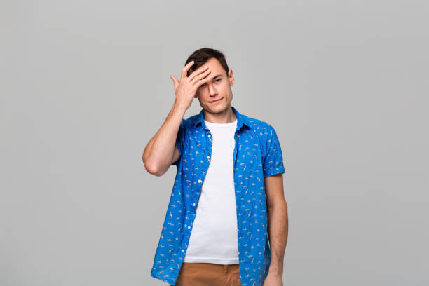 istock Thoughtful handsome man looking at the camera holding hand close to head 1191065648
