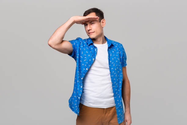 istock Handsome man looking in the distance isolated over grey background. 1191065661