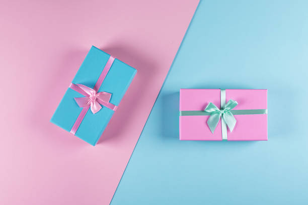 istock Two pastel gift boxes on a blue-pink background. Two-color background. Holiday concept. Top view, flat lay, copy space 1191065665