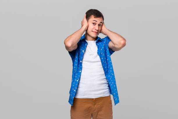 istock Young man covering ears with hands. Gesture of three wise monkeys. 1191065745