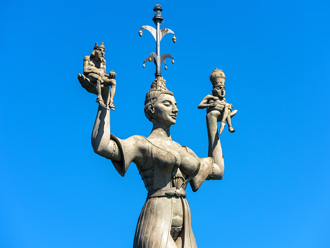 Constance, Germany – July 30, 2019: Famous statue of Imperia in harbor of Konstanz. Imperia is a landmark of city. Big female sculpture at Constance Lake (Bodensee) closeup on blue sky background.