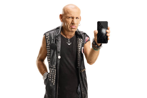 Sad punk holding his broken mobile phone isolated on white background