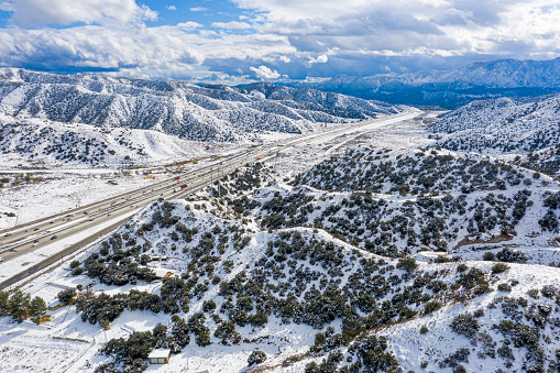The Interstate 5 freeway passes through Grapevine, California with snow.