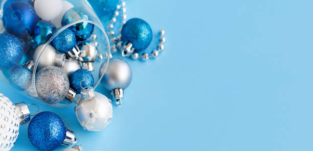 istock Christmas baubles in a wine glass on a light blue background 1191070088