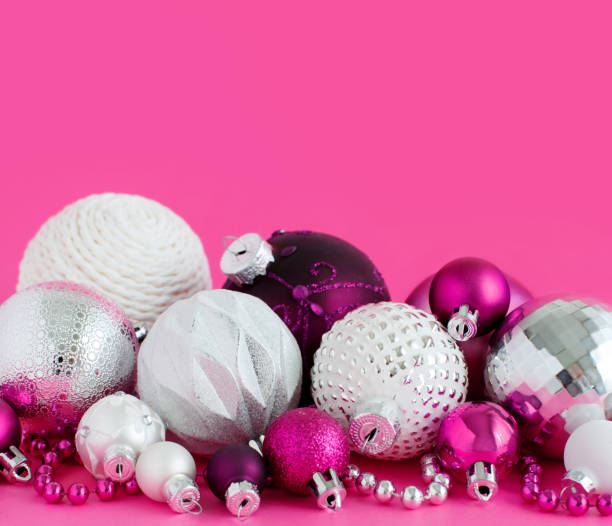 istock Christmas baubles on a pink background 1191070089