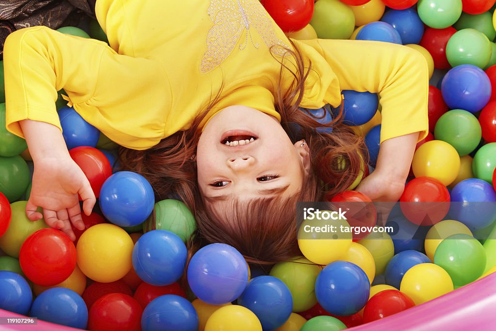 Happy child in group colourful ball.  Child Stock Photo