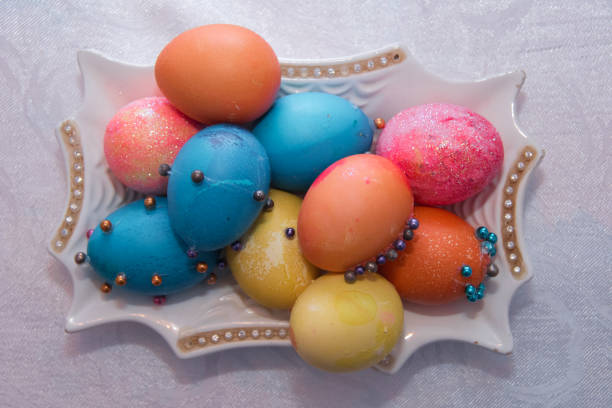 istock Hand colored Easter eggs on vintage plate.Many Colorful Easter Eggs On White Plate Placed By Heap and marble background . Image of several color eggs placed on plate . 1191075402