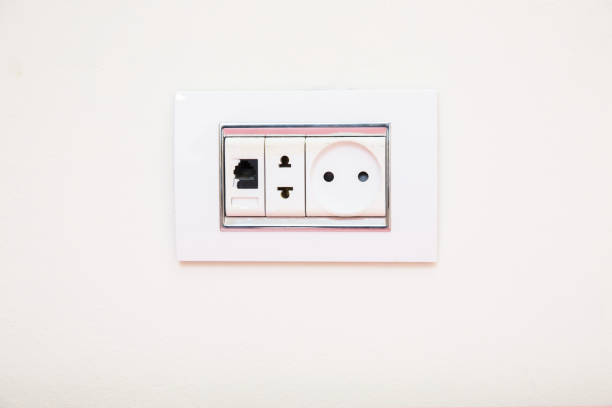 istock a socket on a light gray wall, a multifunction outlet with an internet connection . Electric light switch and socket on the empty wall, electrical power socket and plug switched . 1191075571
