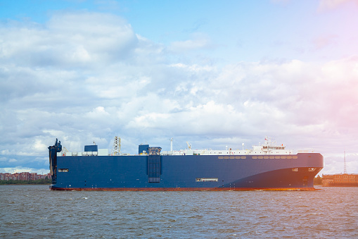 huge blue barge with large containers on board. shipping cargo transportation by sea