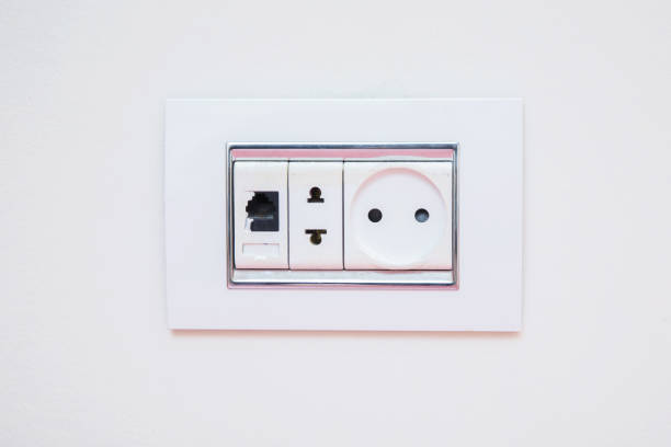 istock a socket on a light gray wall, a multifunction outlet with an internet connection . Electric light switch and socket on the empty wall, electrical power socket and plug switched . 1191075876