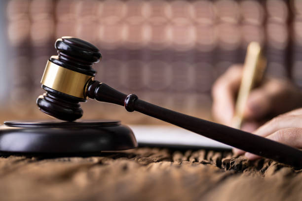 istock Judge Writing On Legal Documents 1191080372